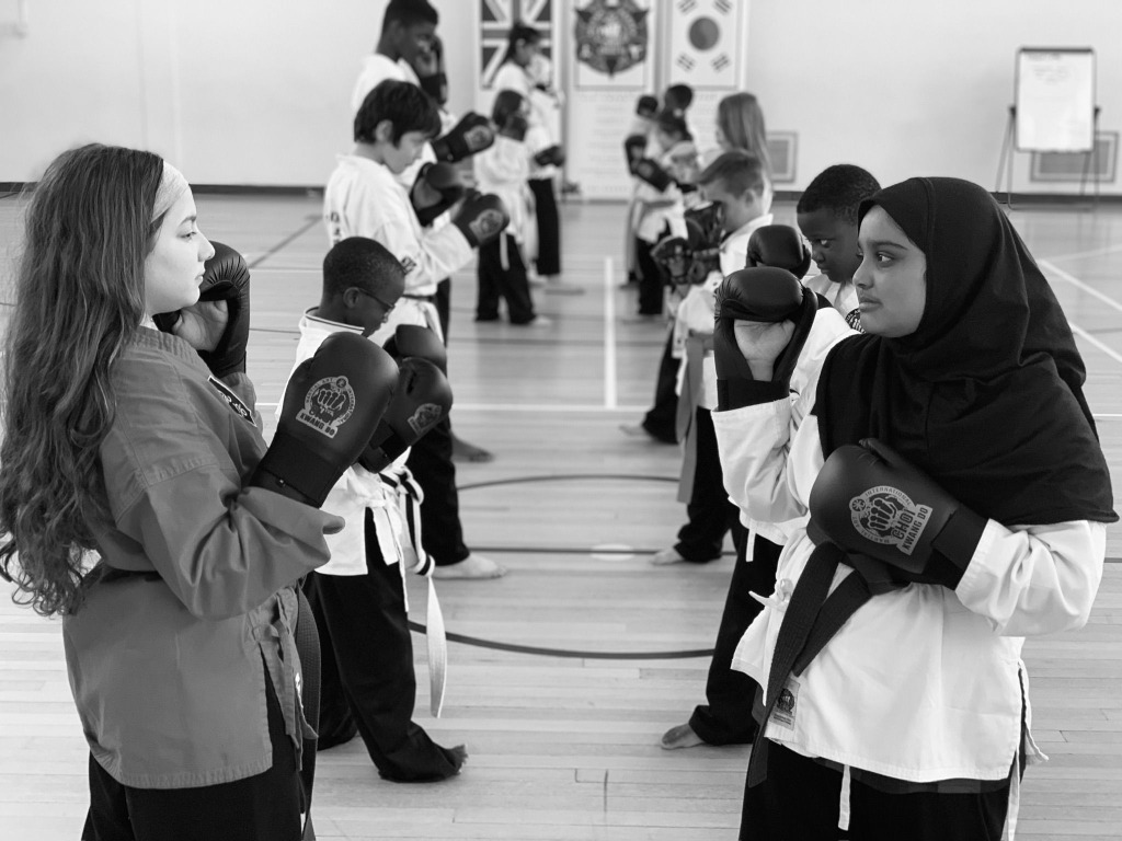 Teenage students training with boxing gloves in Choi Kwang Do
